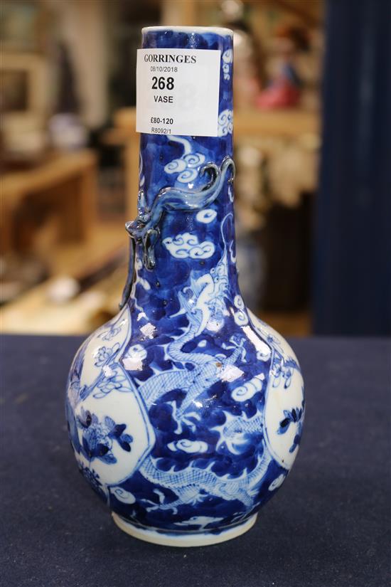 A blue and white vase painted with dragons and birds